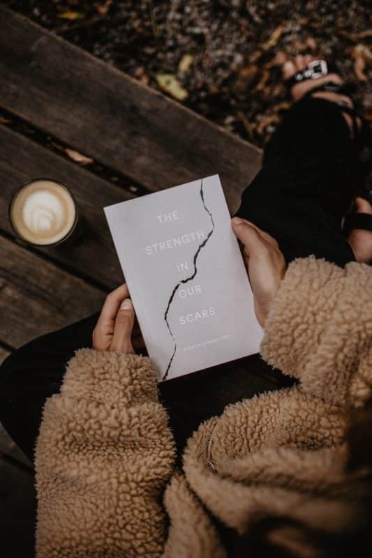 foto keren untuk profil whatsapp instagram telegram tiktok facebook line aestetik estetik perempuan/wanita/cewek memegang buku memakai baju sweater coklat celana hitam ditemani kopi diatas kursi kayu